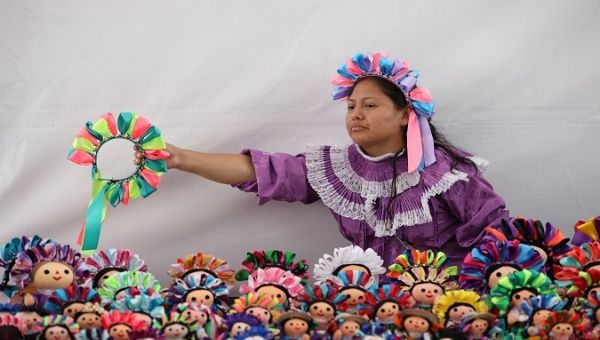 An Indigenous Otomies woman sells dolls in Mexico City, Mexico, Dec. 17, 2019.
