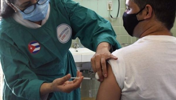 A medical worker administers a dose of locally made COVID-19 vaccine 