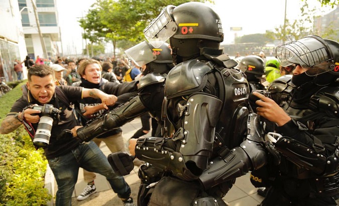 Police officers attack a photojournalist, Colombia, 2021.