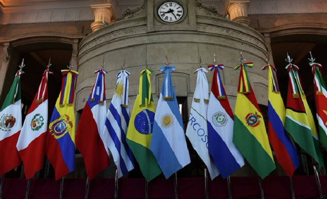 Mercosur flag (C) surrounded by flags of Latin American countries.