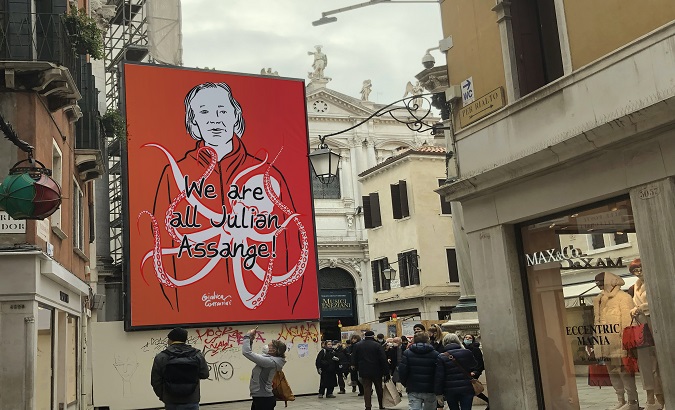 A sign supporting Julian Assange hangs on a street, Venice, Italy, Dec. 28, 2021.