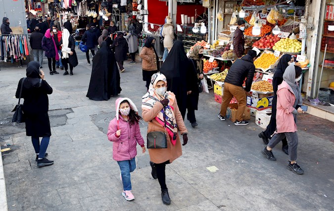 Iranians walk at a street market in Tehran, Iran, 28 December 2021.