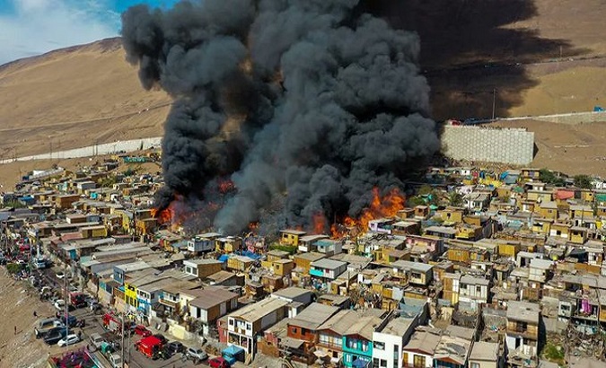 Fire destroys wood houses, Iquique, Chile, Jan. 10, 2022.