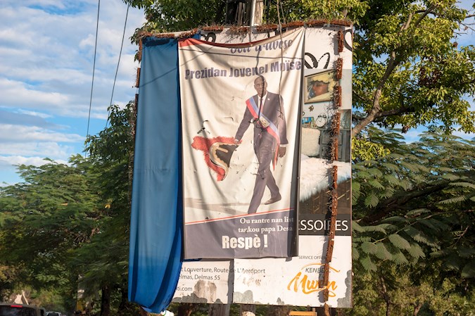 Photo of a banner hanging on a street with the image of assassinated President Jovenel Moise, January 6, 2022, in Pétion-ville, Haiti.