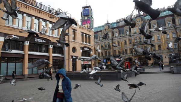 Pigeons fly at a central square in Kiev, Ukraine