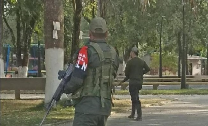 National Liberation Army (ELN) members patrol a town, Colombia.