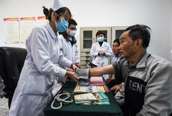 Medical workers provide free medical care service to the elders at a university for senior citizens of Zhongshan District in Liupanshui, southwest China's Guizhou Province, Oct. 14, 2021.