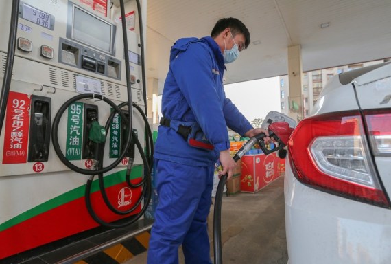 A member of staff refills the tank of a car at a gas station in Lianyungang City, east China's Jiangsu Province, Feb. 18, 2021.