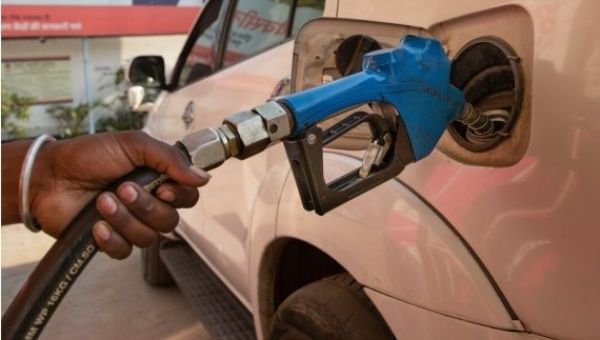 A staff member refuels a vehicle at a gas station in New Delhi, April 6, 2022.