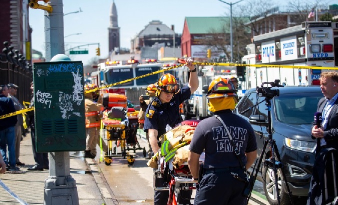First responders work at a nearby street after the subway station shooting, NYC, U.S., April 12, 2022.