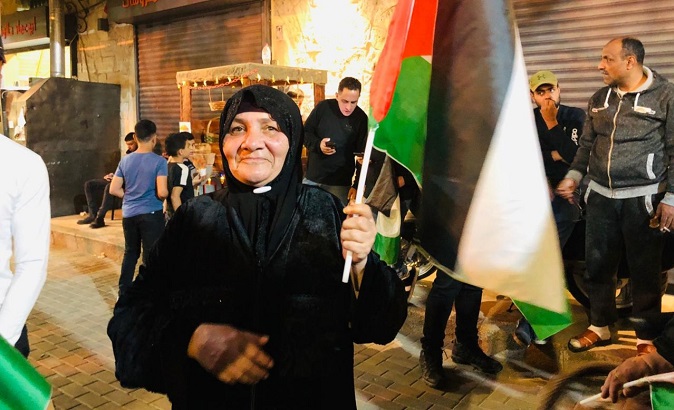 A woman holding a Palestine flag.