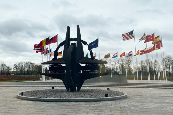 Photo taken on April 6, 2022 shows a sculpture and flags at NATO headquarters in Brussels, Belgium