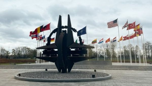 Photo taken on April 6, 2022 shows a sculpture and flags at NATO headquarters in Brussels, Belgium