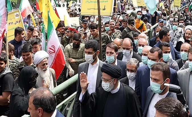 President Ebrahim Raisi (R) in a pro-Palestine demonstration, Iran, April 28, 2022.