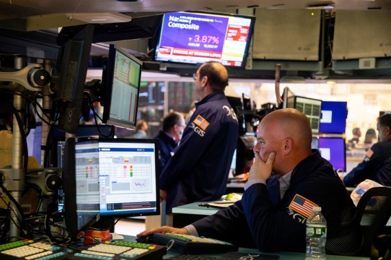 Traders work on the floor of the New York Stock Exchange (NYSE) in New York, the United States, April 26, 2022.