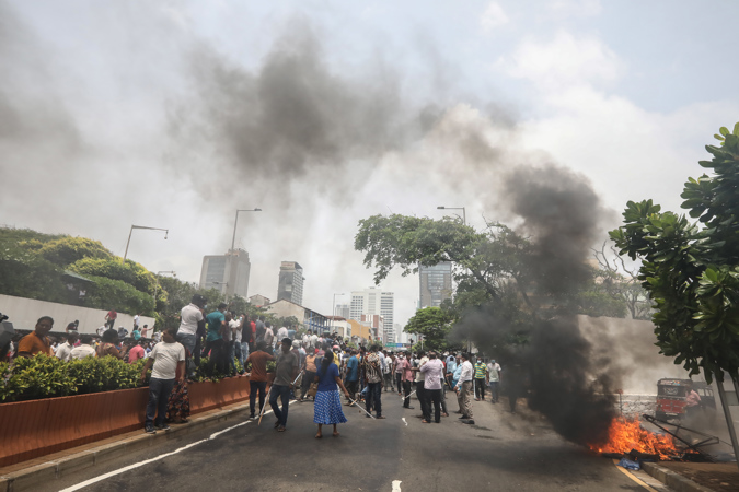 Government supporters torch tents of anti-government protesters during clashes near the prime minister's house in Colombo, Sri Lanka, 09 May 2022.