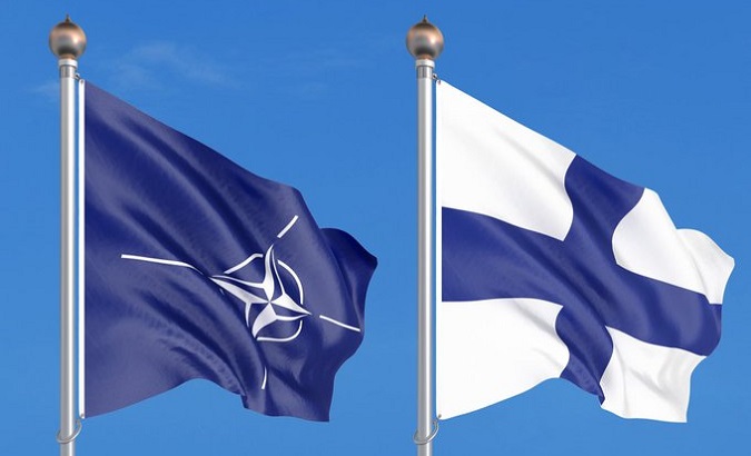 Flags of the NATO (L) and Finland (R).