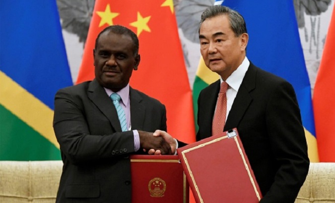 Solomon Islands Foreign Minister Jeremiah Manele (L) & Chinese Foreign Minister Wang Yi (R), 2019.