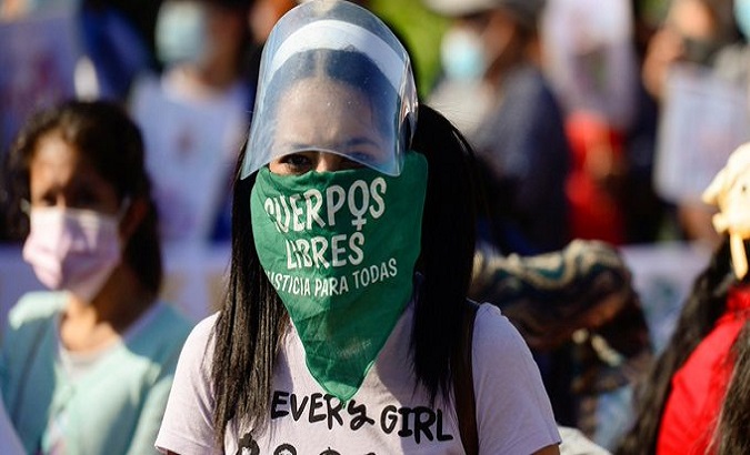 A woman wears a handkerchief calling for abortion decriminalization, El Salvador.