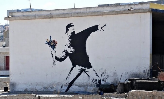 Replica of the flower thrower painted by Banksy in Bethleem, Palestine.