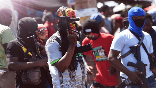Armed gang members stand guard in a neighborhood, Haiti. 
