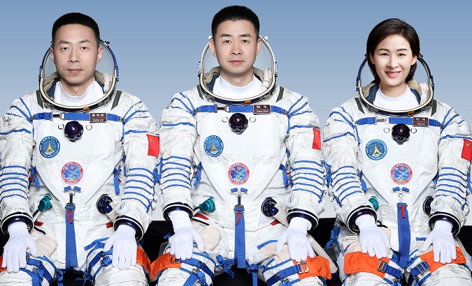 Chinese astronauts Chen Dong (C), Liu Yang (R) and Cai Xuzhe (L).