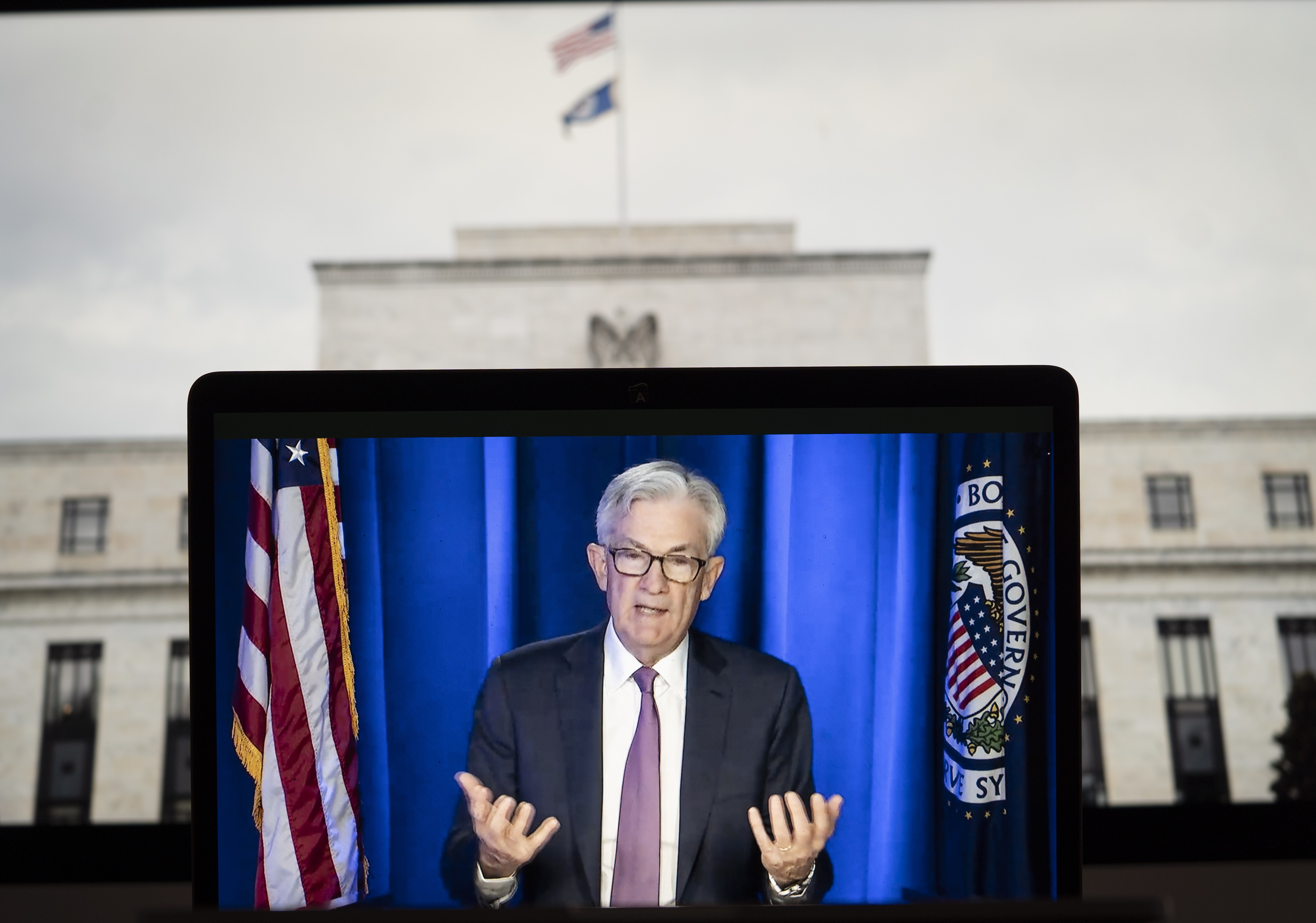 Photo taken in Arlington, the United States, on March 16, 2022 shows a screen displaying U.S. Federal Reserve Chairman Jerome Powell speaking during a virtual press conference.