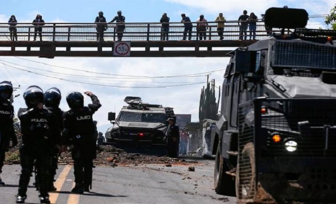 Security forces near a roadblock in Quito, Ecuador, June 16, 2022.