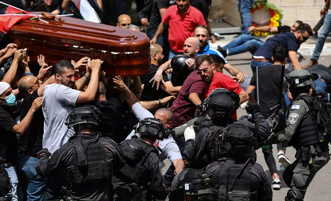 Israeli police attack mourners carrying the coffin of Shireen Abu Akleh, in occupied East Jerusalem, May 13, 2022.