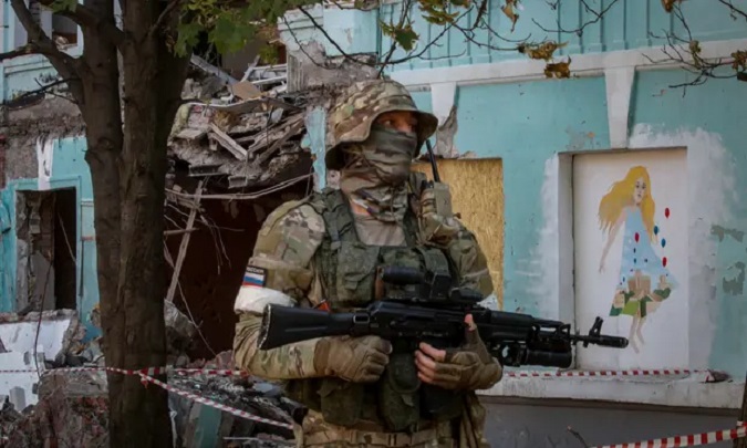 Russia-Ukraine War: A Russian serviceman next to a school destroyed by shelling in downtown Donetsk on June 14, 2022.