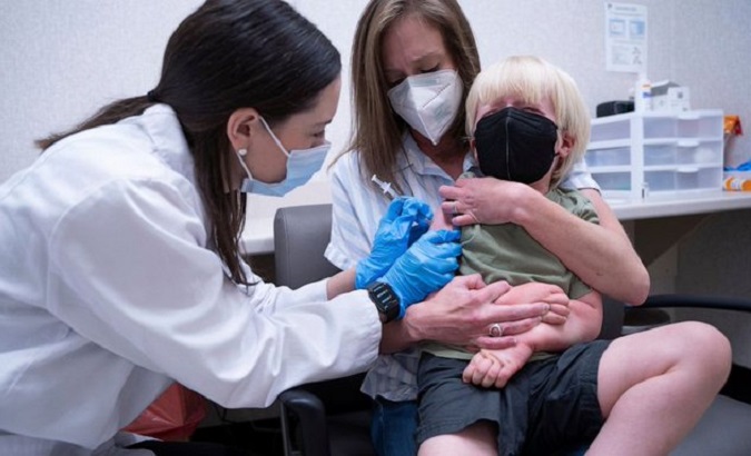 A child gets a COVID-19 vaccine, 2022.