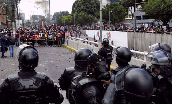 Police try to contain the advance of Indigenous people along 10 de Agosto Avenue, Quito, Ecuador, June 21, 2022.