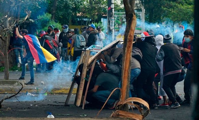 Citizens protect themselves from the gas bombs launched by the Police, Quito, Ecuador, June 22, 2022.
