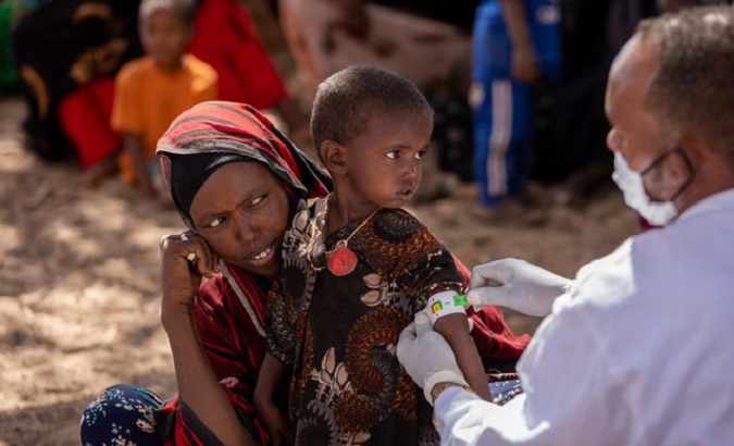 Doctor attends to displaced people, Ethiopia, 2022.