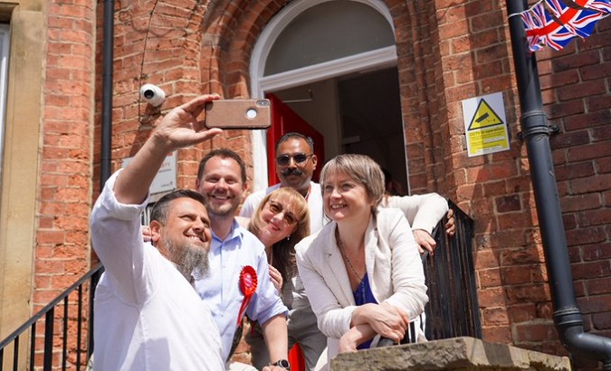 People take a selfie with Labor candidate Simon Lightwood (2L), U.K., June 17, 2022.