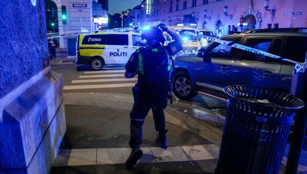 Police officers secure the scene after a report of several shots fired outside the London pub in the center of Oslo, Norway, 25 June 2022.
