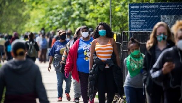People wait in line to receive free face masks at the Prospect Park in the Brooklyn borough of New York, the United States, May 3, 2020.