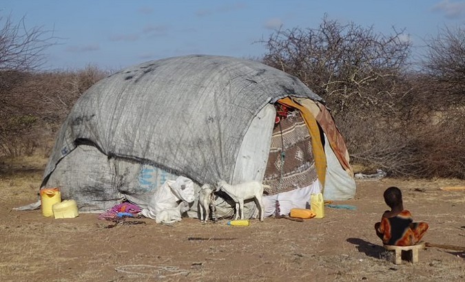 An African boy near a makeshift shelter, 2022.