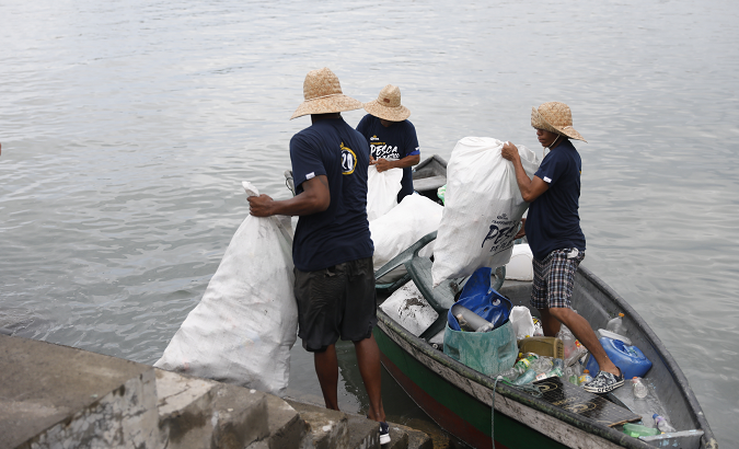 Fishermen collect plastic from the sea, July 10, 2022.