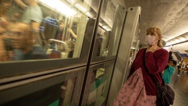 A woman wearing a face mask waits at a subway station in Paris, France, July 8, 2022.