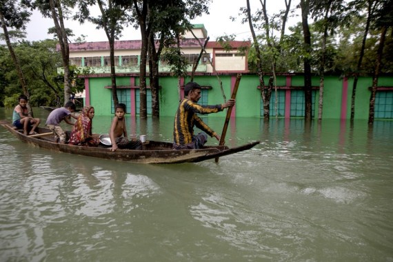 People move by boat from a flood-affected area to a safe place in Sylhet, Bangladesh, on June 19, 2022.