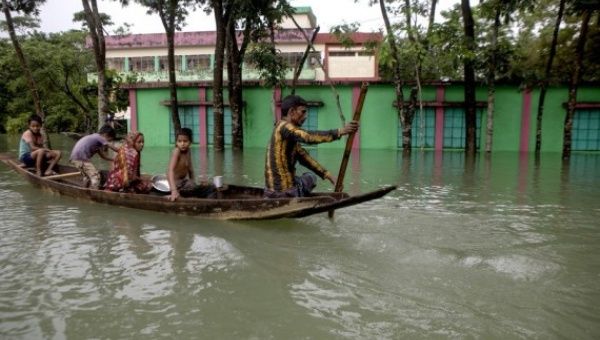 People move by boat from a flood-affected area to a safe place in Sylhet, Bangladesh, on June 19, 2022.