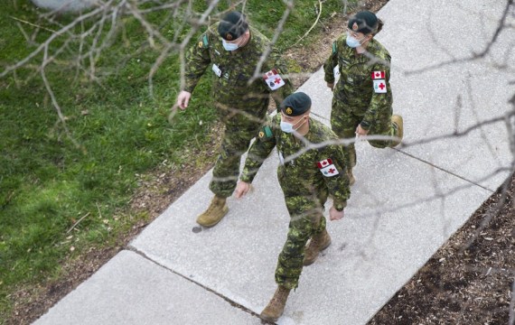 Members of the Canadian Armed Forces wearing face masks walk outside a mobile hospital at a parking lot of Sunnybrook Health Sciences Centre in Toronto, Ontario, Canada, on April 30, 2021.