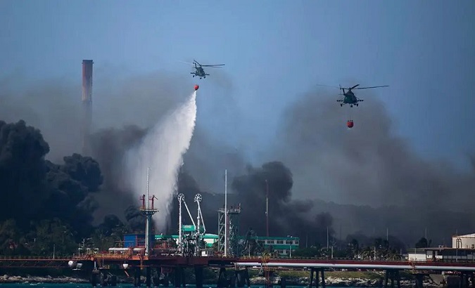 Helicopters dump seawater on the fire in Matanzas, Cuba, Aug. 8, 2022.