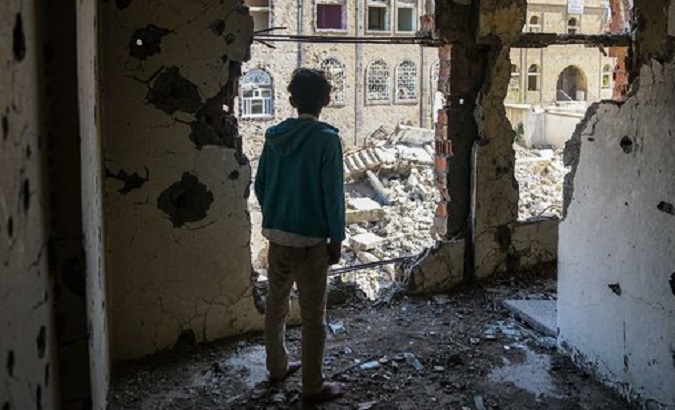 A boy looks at the destruction caused by the war in Yemen, Aug. 2022.
