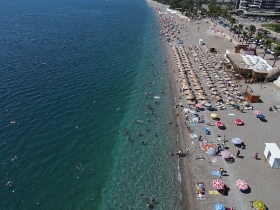 People enjoy time on the beach in Antalya, Türkiye, on Sept. 11, 2022.