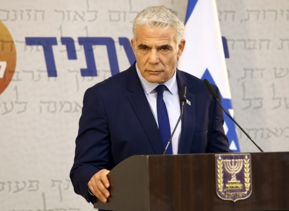 Israeli Prime Minister and Head of the Yesh Atid party Yair Lapid speaks during a faction meeting in Tel Aviv on Aug. 25, 2022.