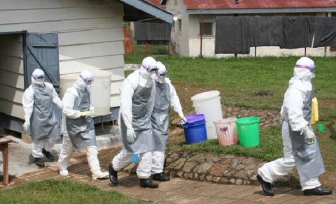 Health workers attend to an Ebola case, Uganda, Sept. 2022.