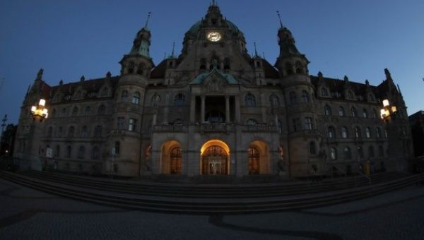 Photo taken on Aug. 1, 2022 shows a night view of the city hall in Hanover, Germany. Some landmark structures across the country have reduced their night illumination to save electricity.