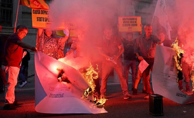 Italian workers burn utility bills.